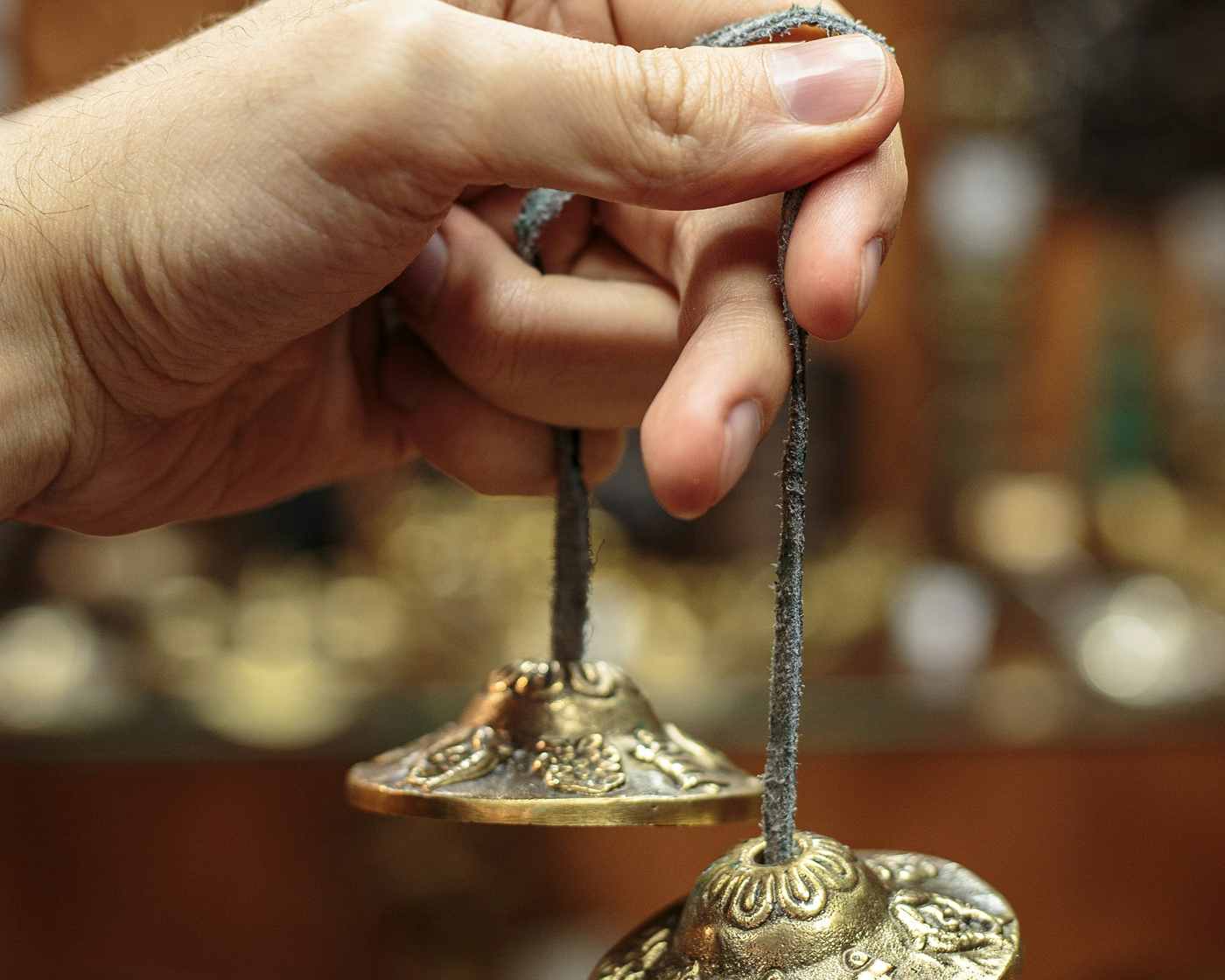 hand holding traditional tibetan chimes