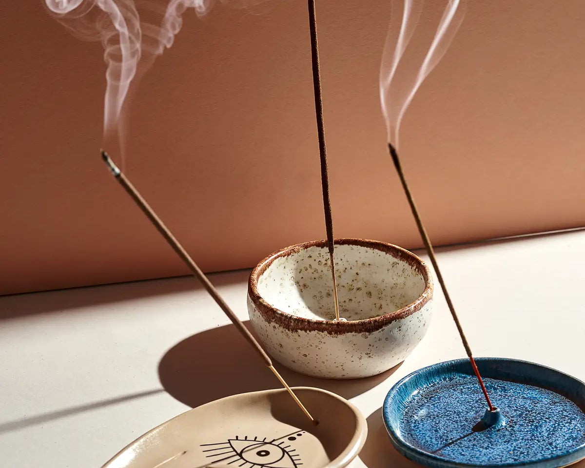 three incense sticks in holders