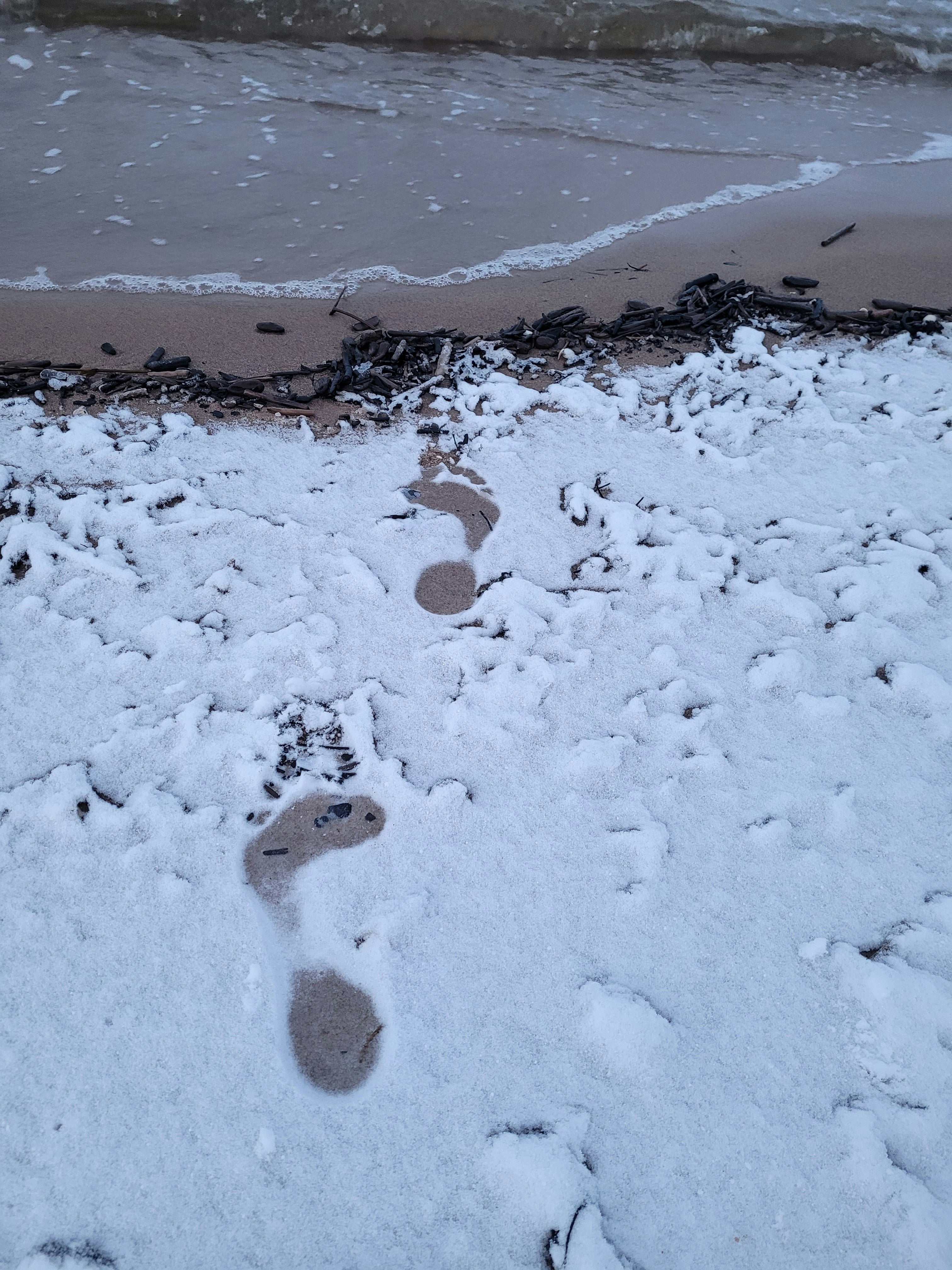 footprints in snow on beach