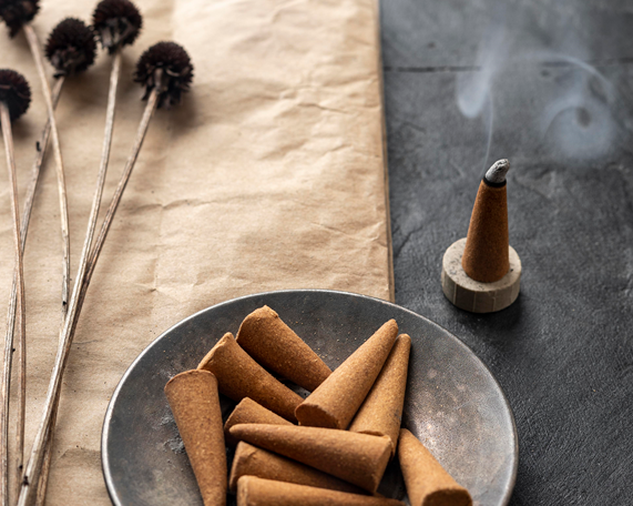 burning incense cone and unused cones