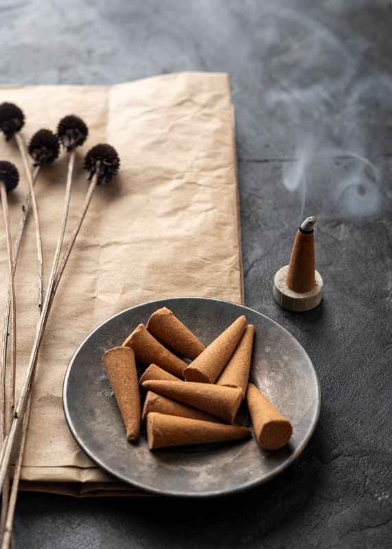 burning incense cone and unused cones