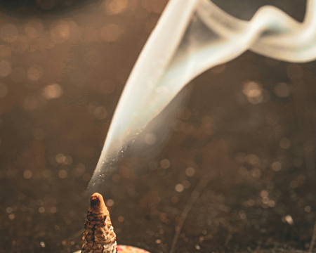 burning incense cone or small holder