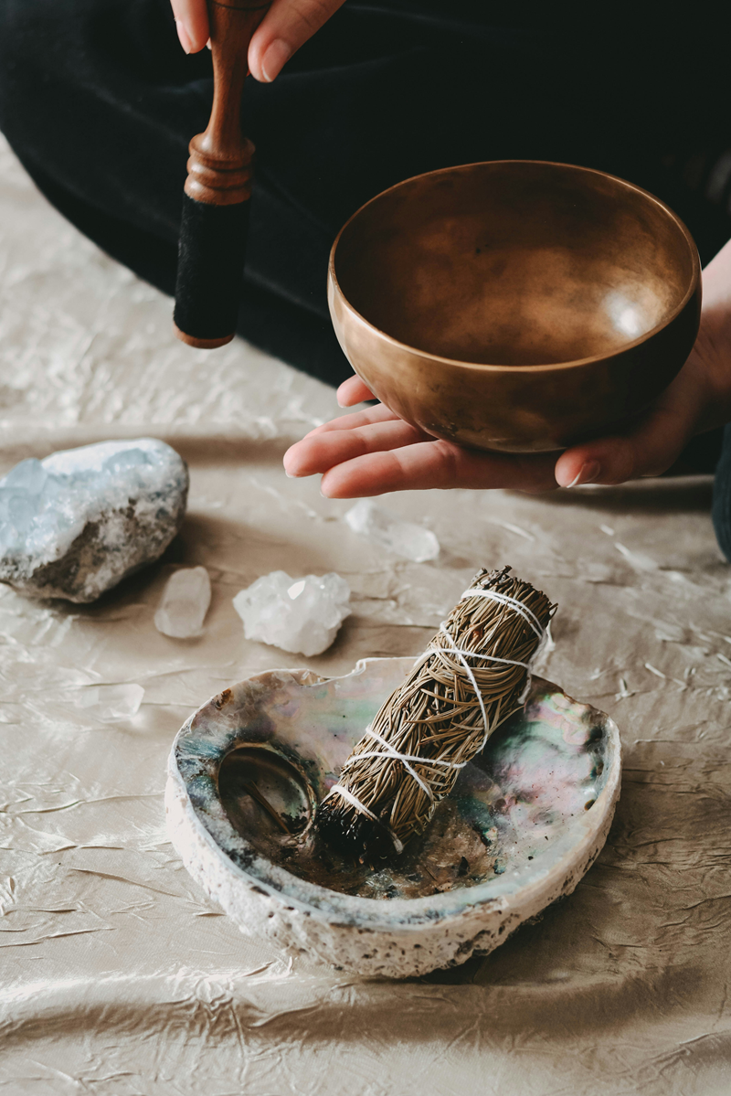 smudge stick in abalone shell bowl and singing bowl