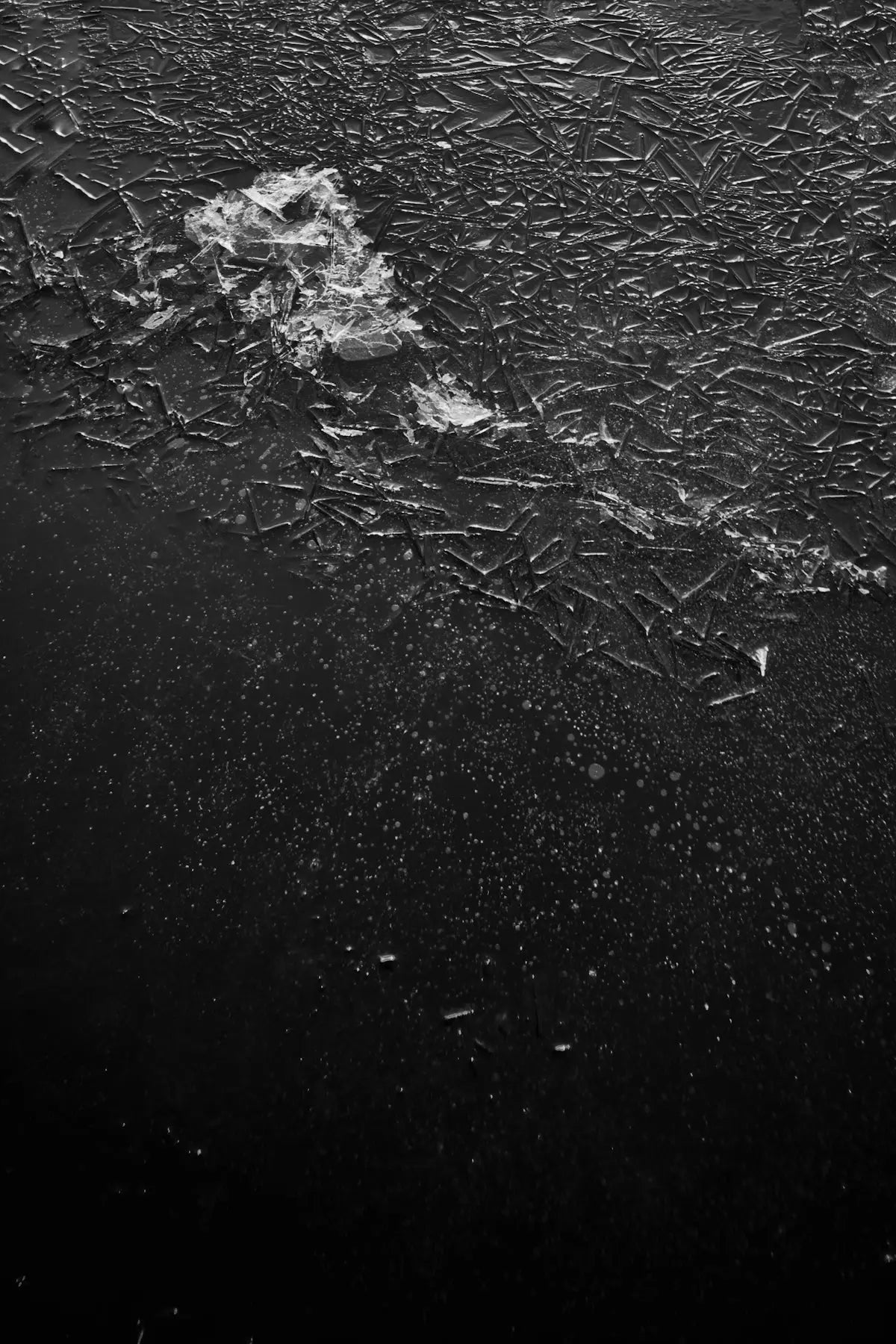 A black and white photo of a person riding a surfboard