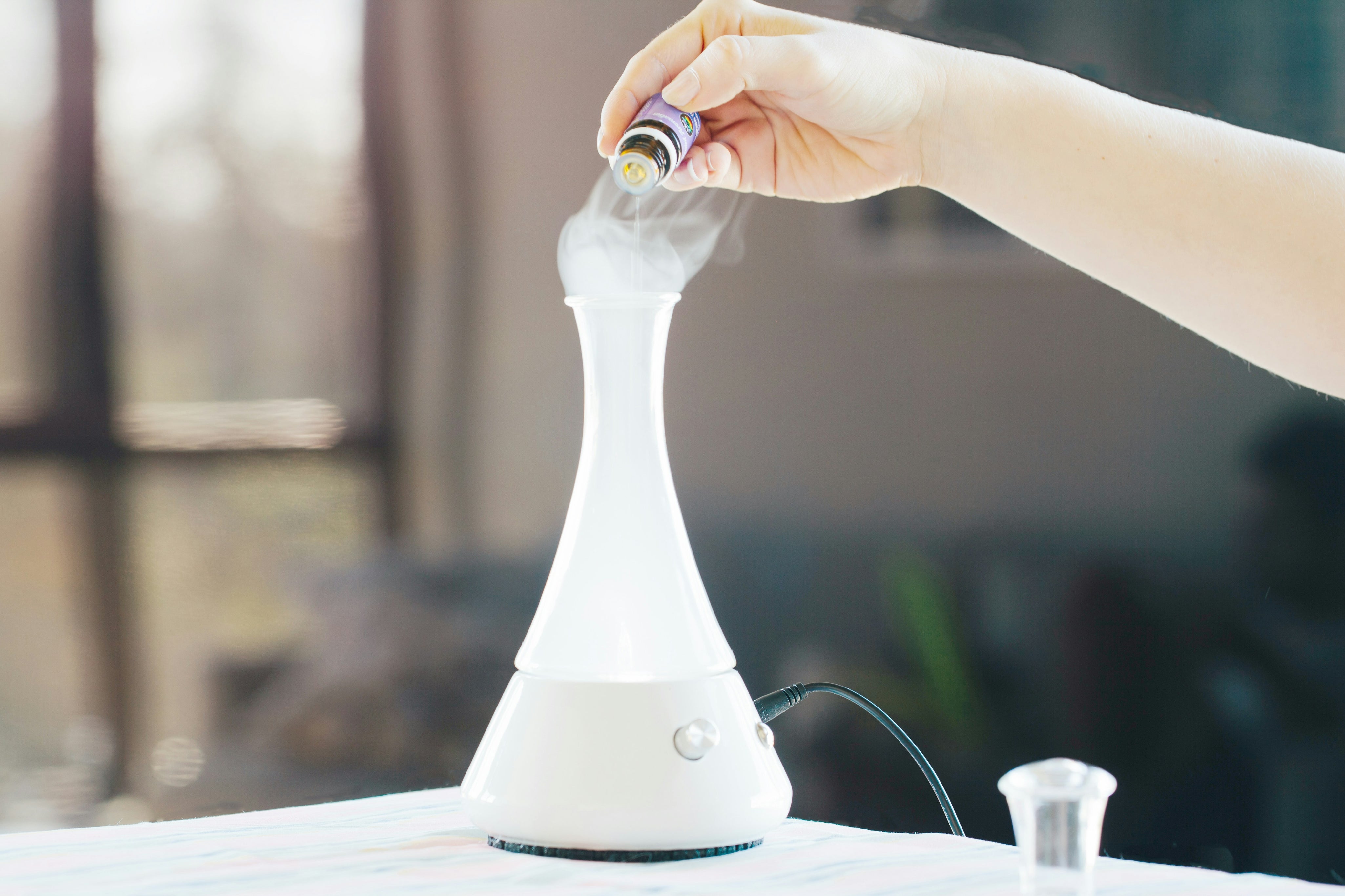 putting essential oil in diffuser