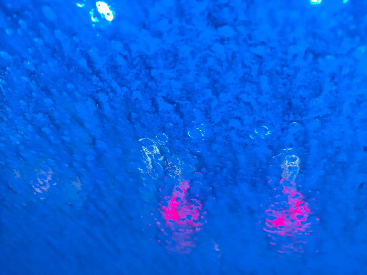 a close up of a street light in the rain