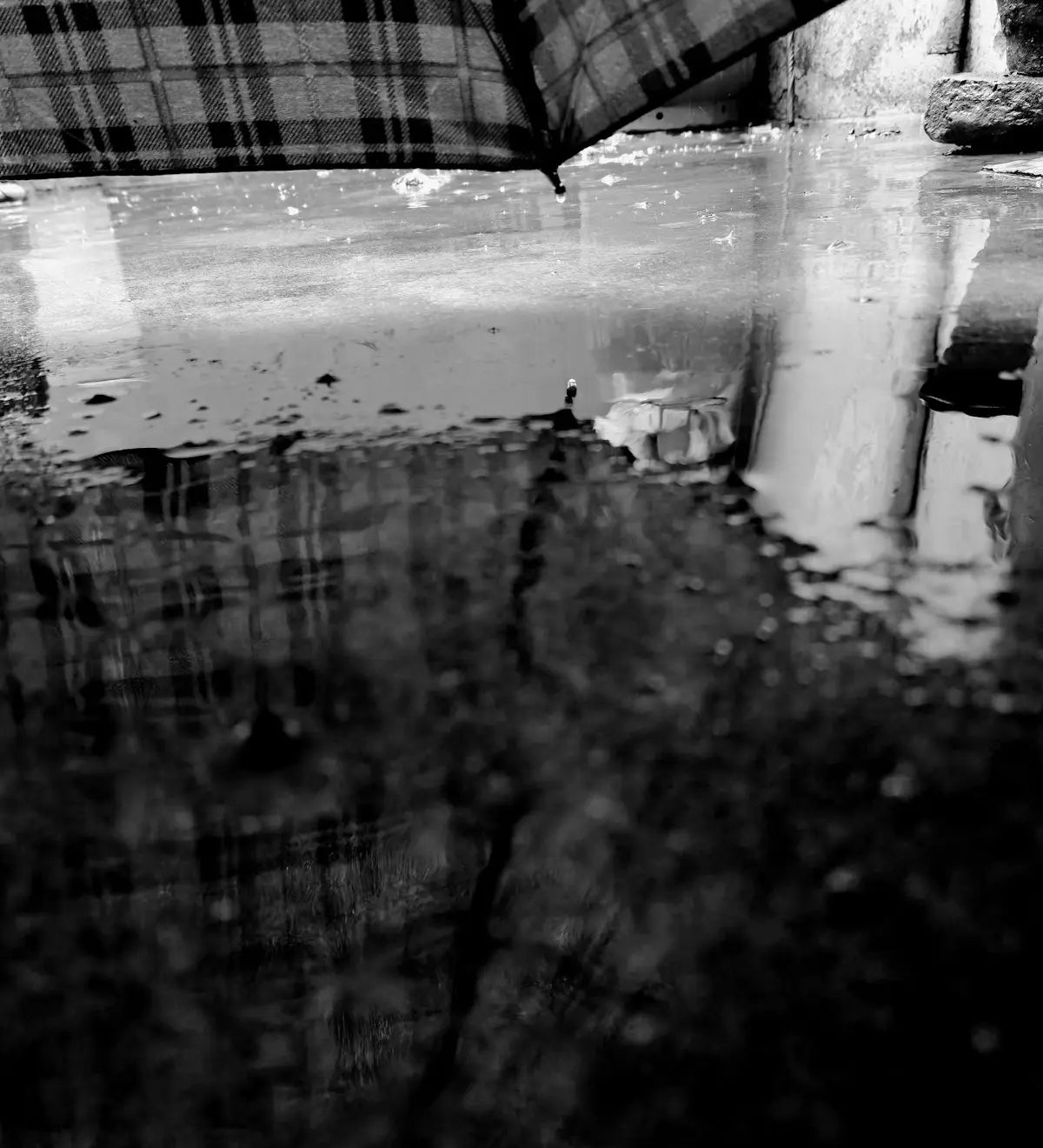 A black and white photo of a person holding an umbrella
