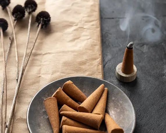 burning incense cone and unused cones