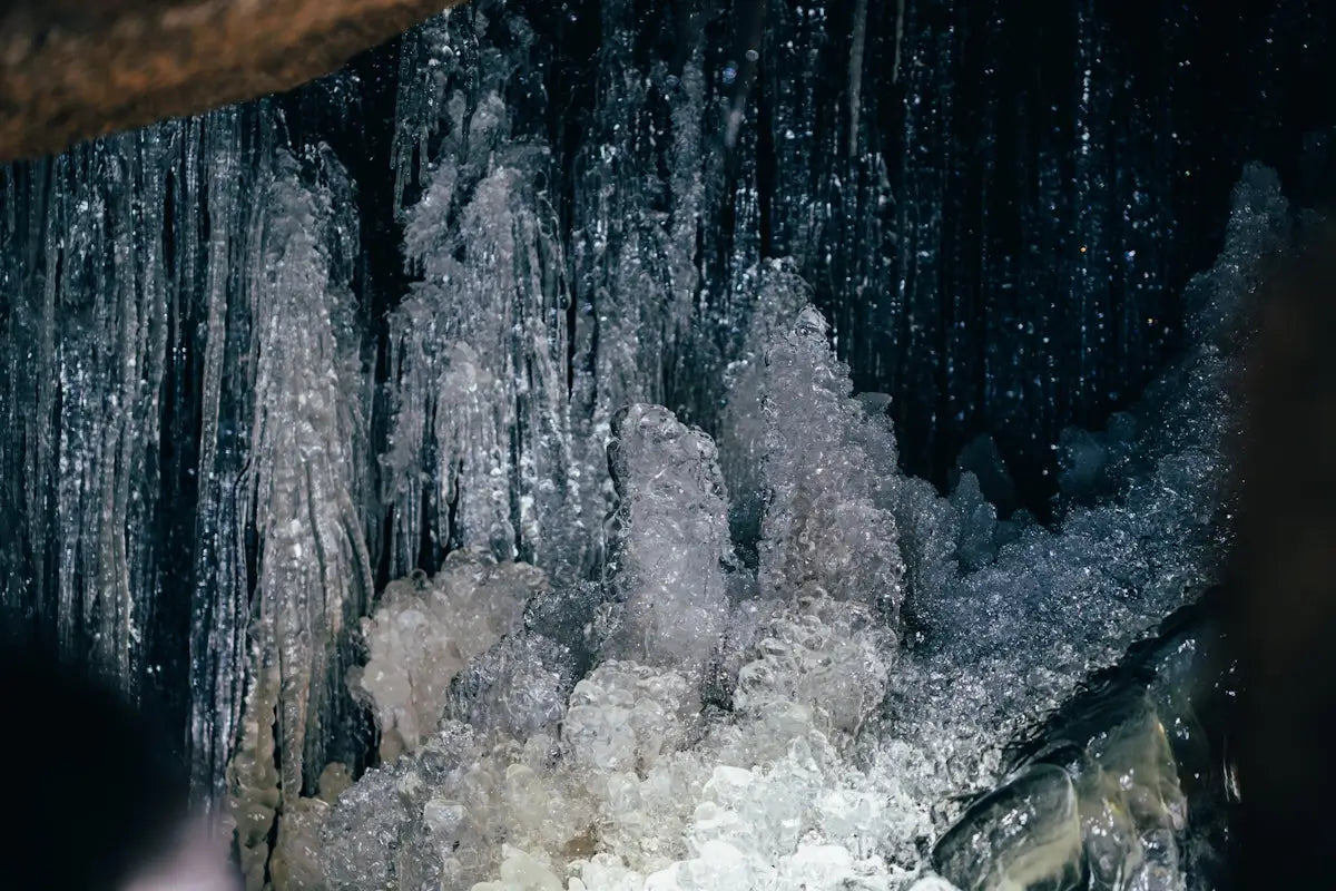 a group of icicles hanging from the ceiling of a cave
