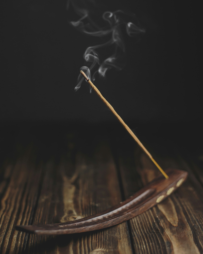 burning incense stick in holder