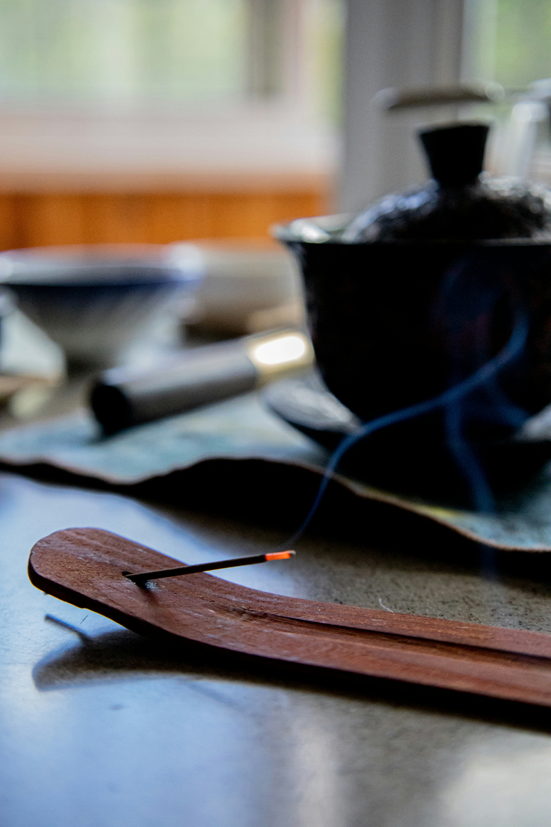 nearly finished burning incense stick in holder