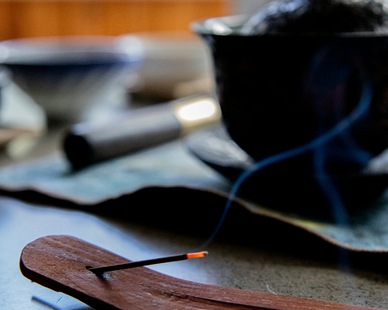 nearly finished burning incense stick in holder