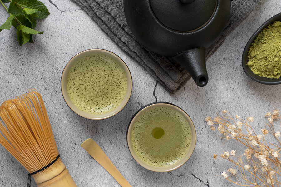 matcha tea with teapot and whisk