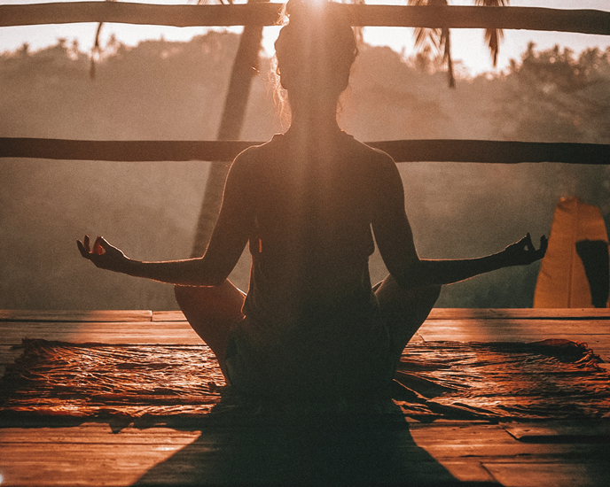 woman meditation on deck at sunrise