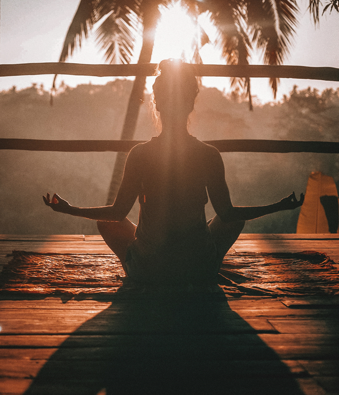 woman meditation on deck at sunrise