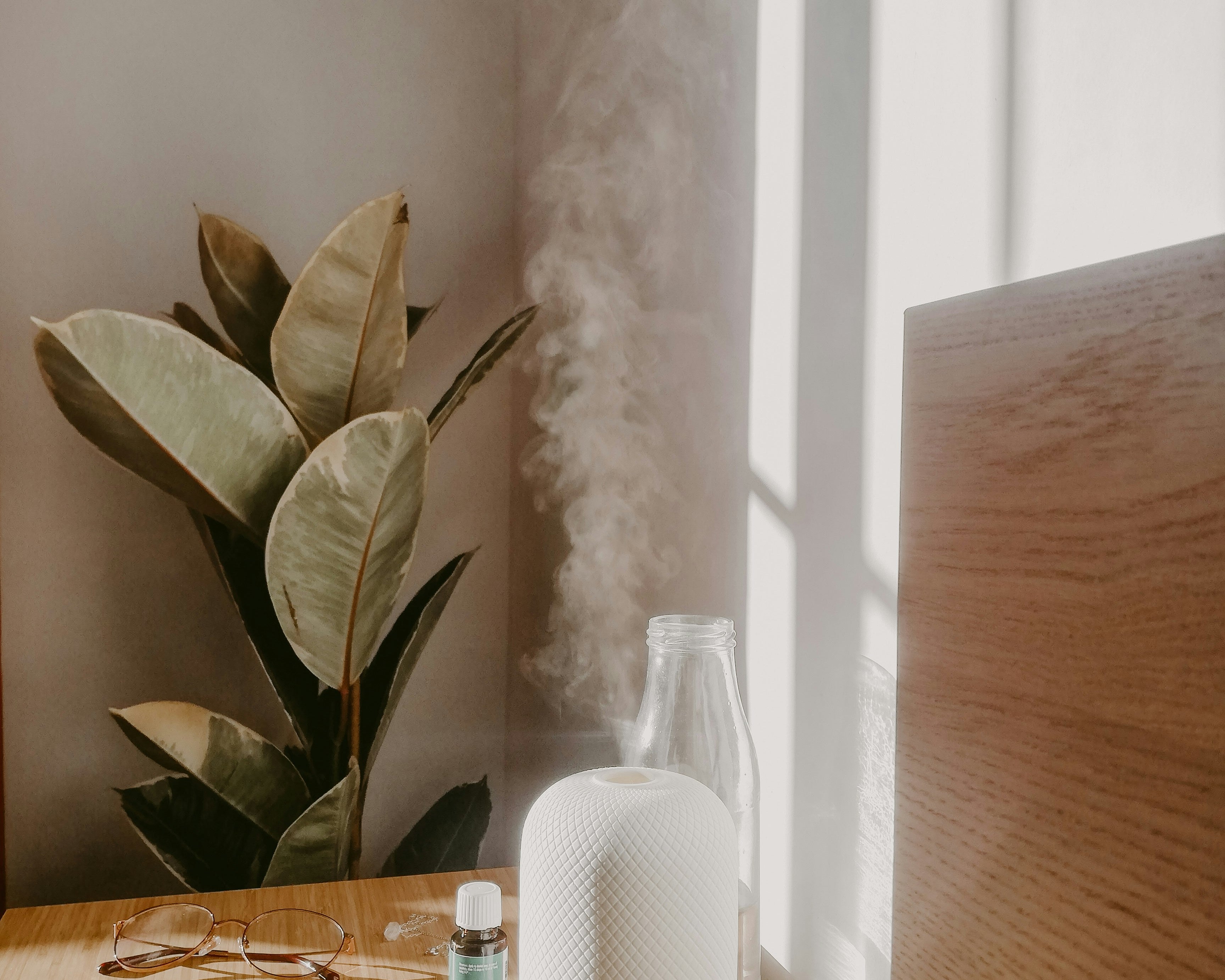 nebulizing essential oil diffuser on desk with oil