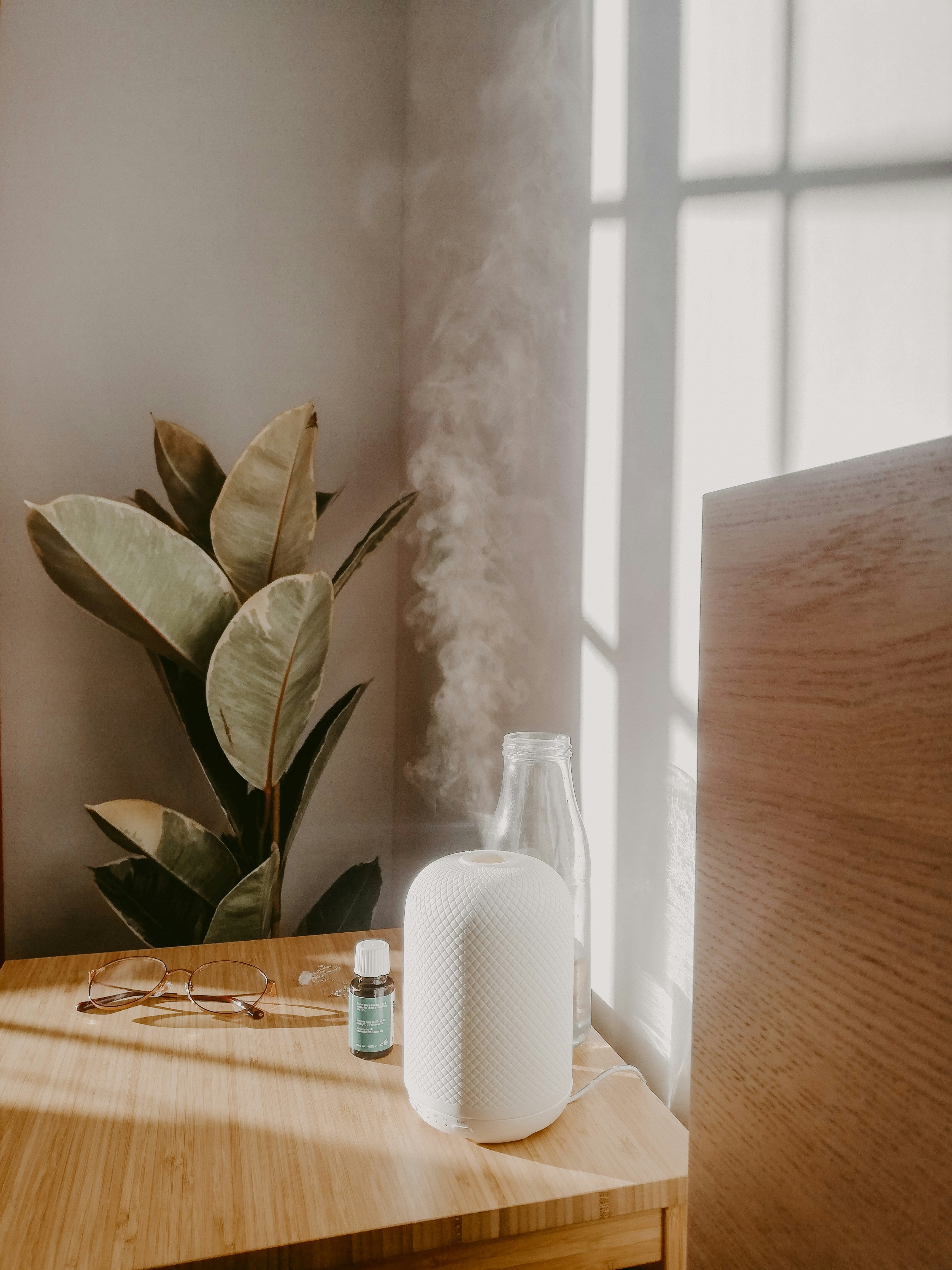 nebulizing essential oil diffuser on desk with oil