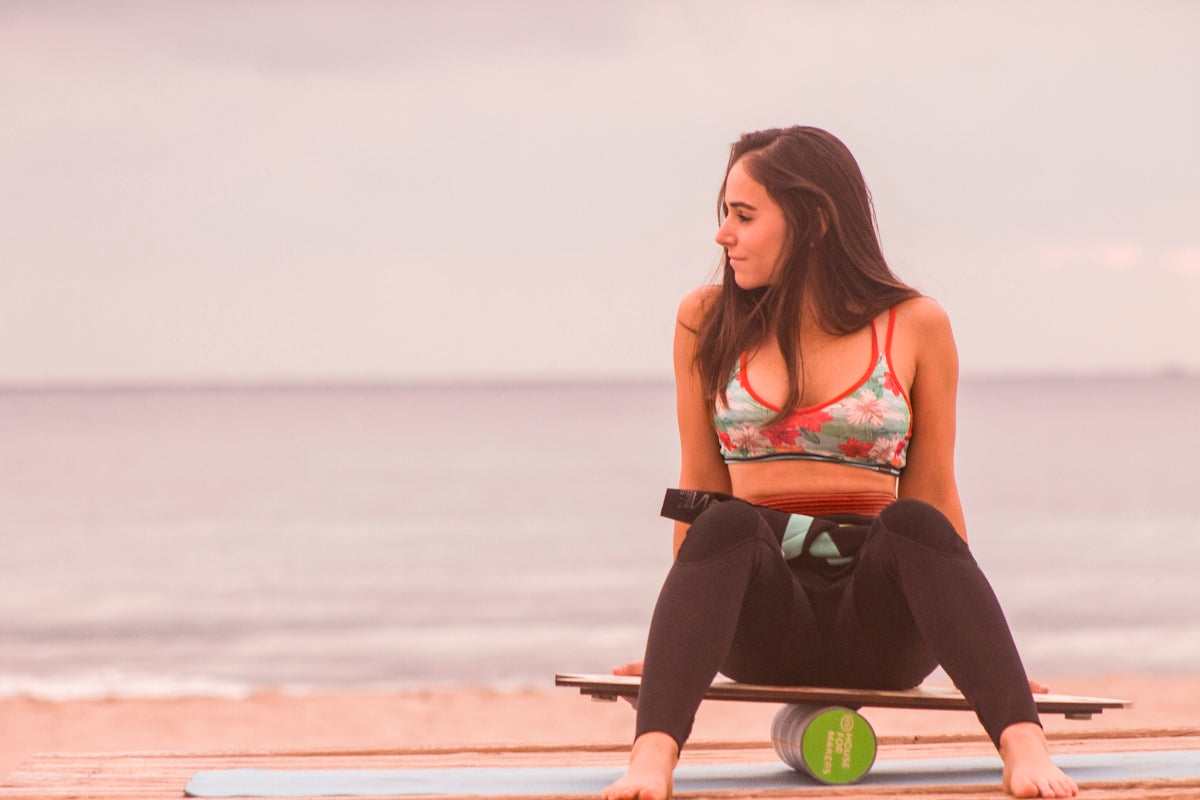 woman sitting on board balancing on canister