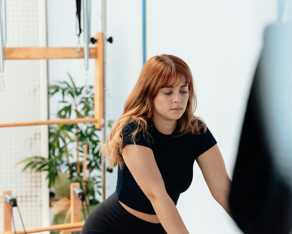 a woman on a rowing machine in a gym