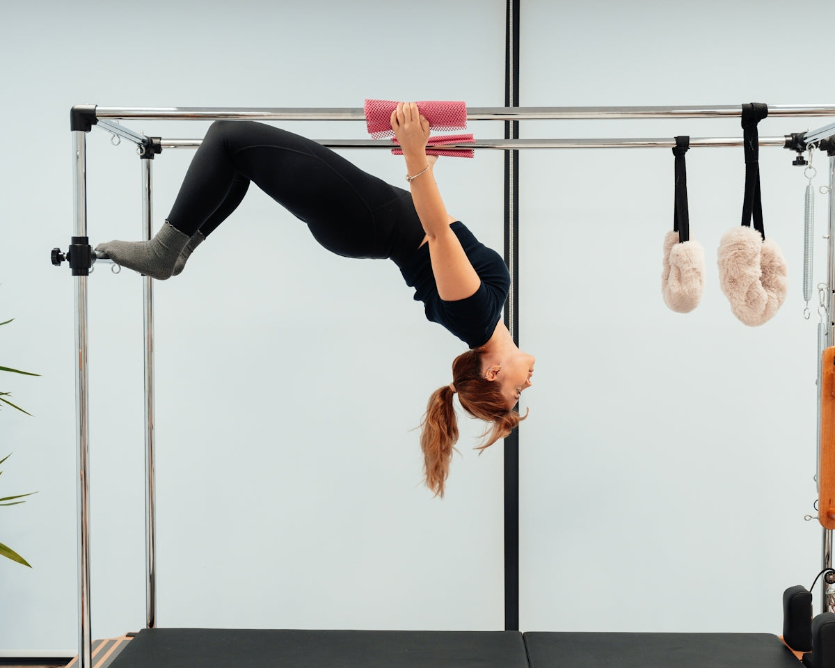 a woman doing a handstand on a pivot exercise