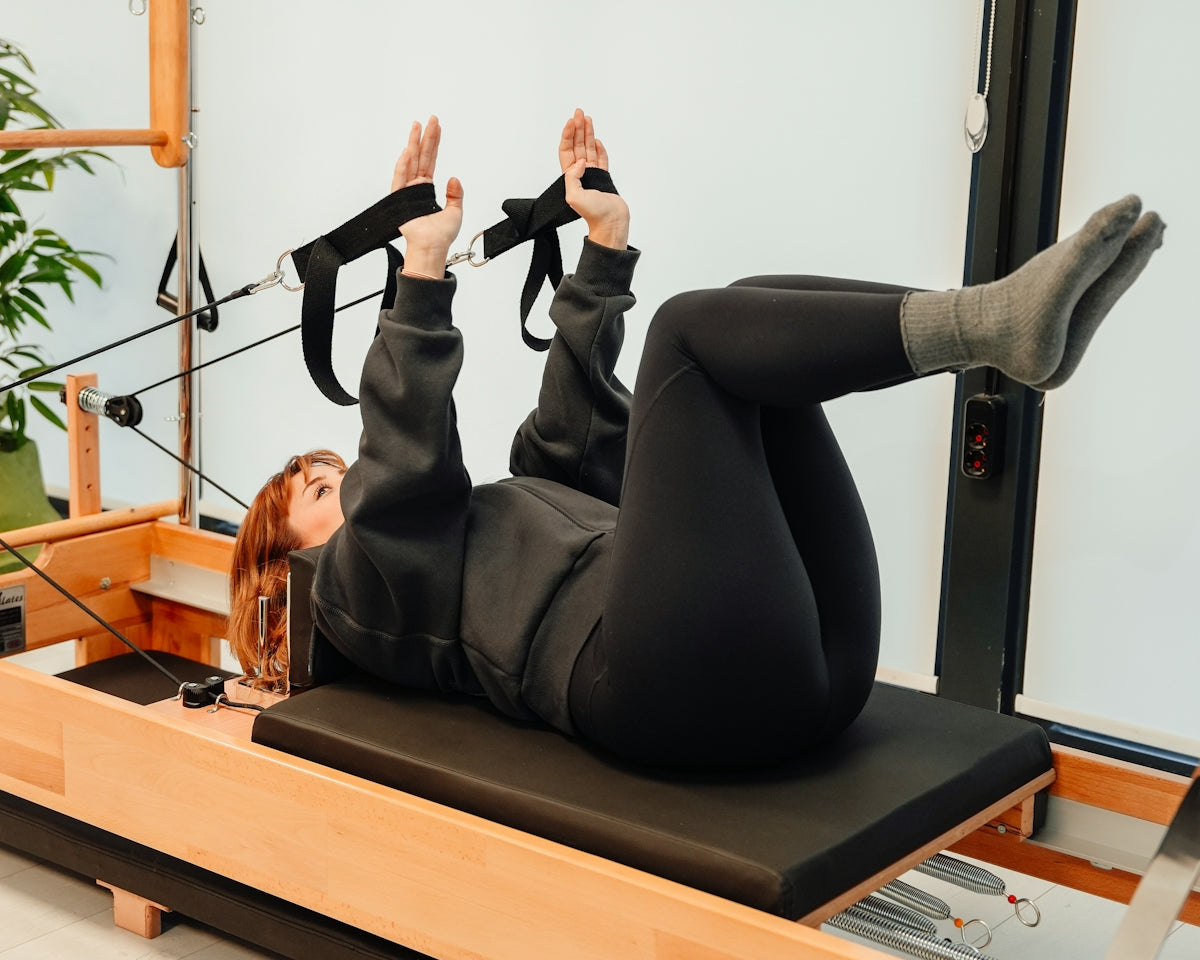 a woman is doing exercises on a rowing machine