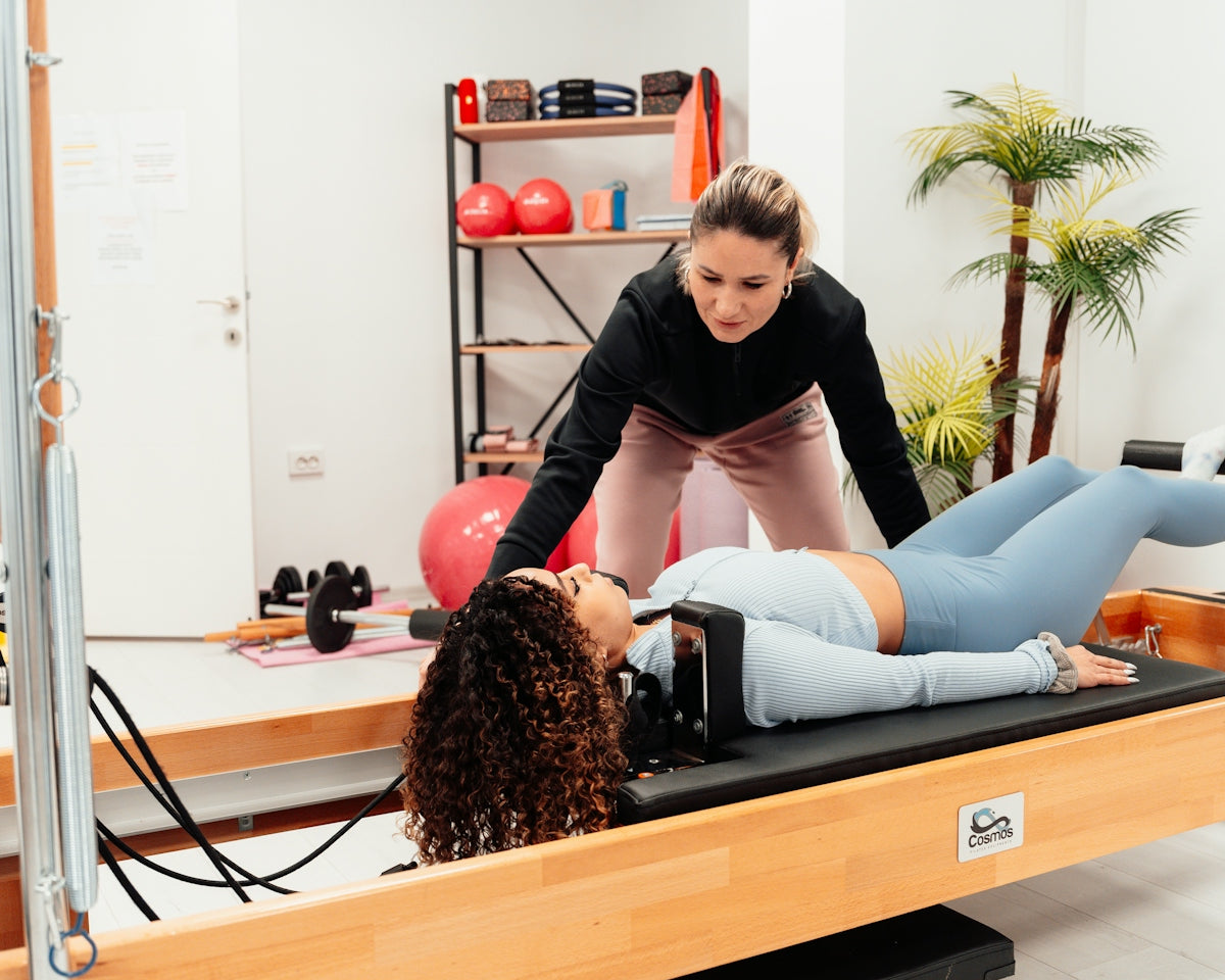 a couple of women are doing exercises in a gym