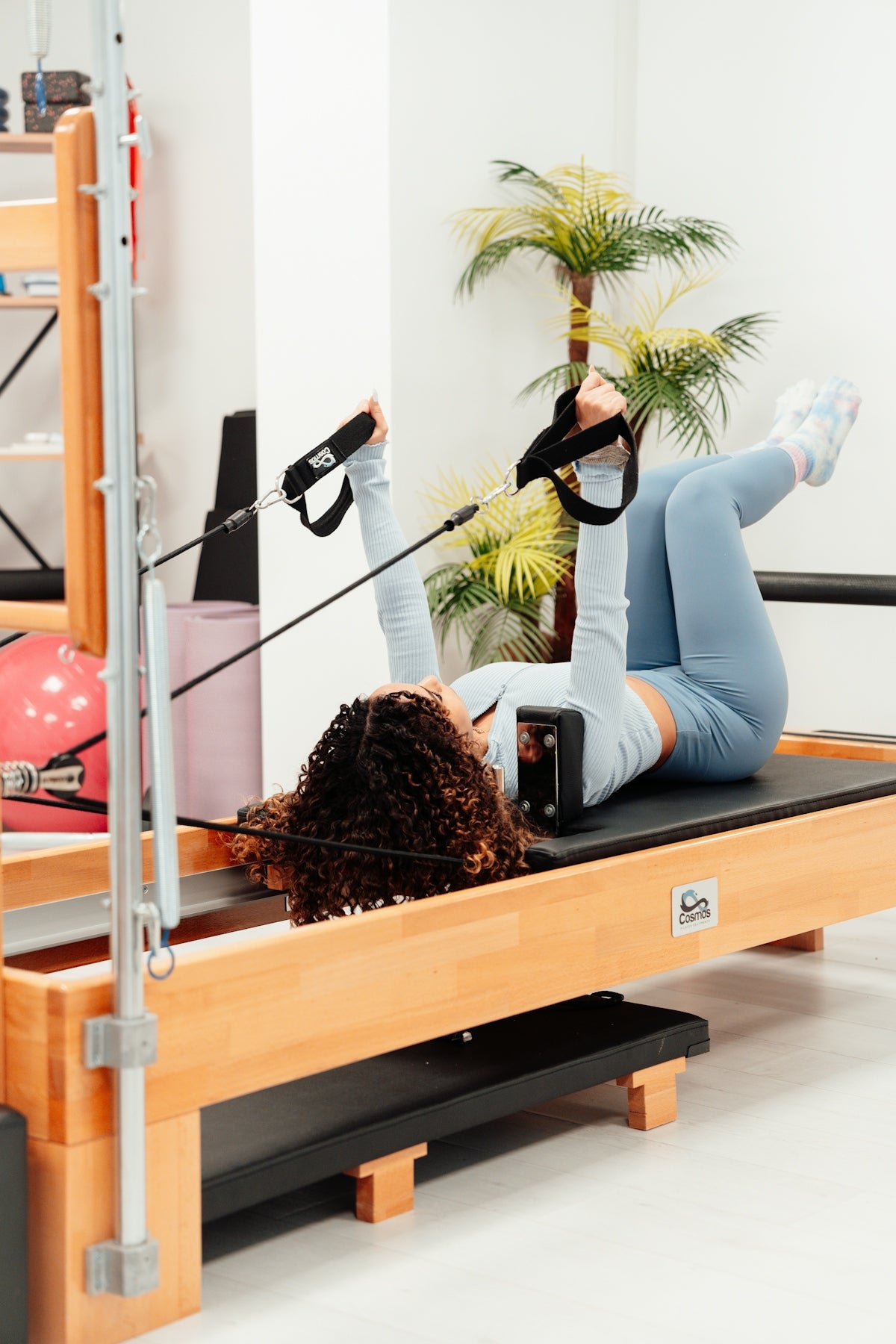 a woman in a gym doing exercises on a rowing machine