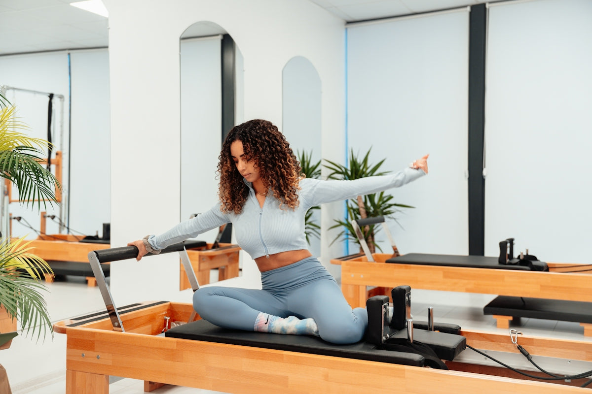 a woman is doing a piyoma exercise in a gym