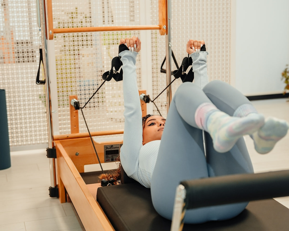 a woman doing exercises on a machine in a gym