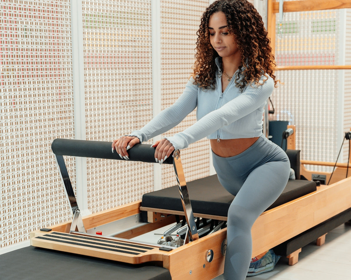 a woman is doing exercises on a rowing machine