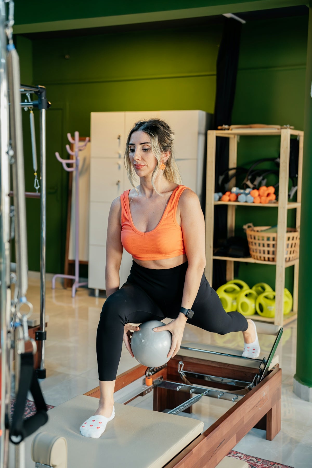 Woman does pilates exercise with a ball.