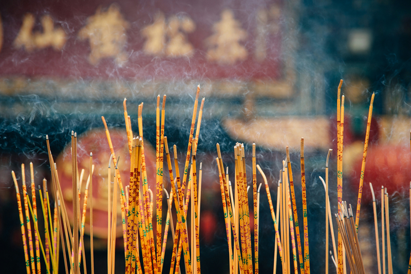 several lit incense sticks being used