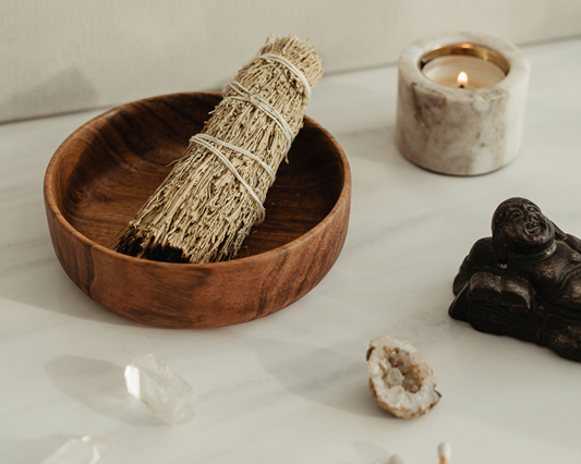 smudge stick in timber bowl with crystals and candle