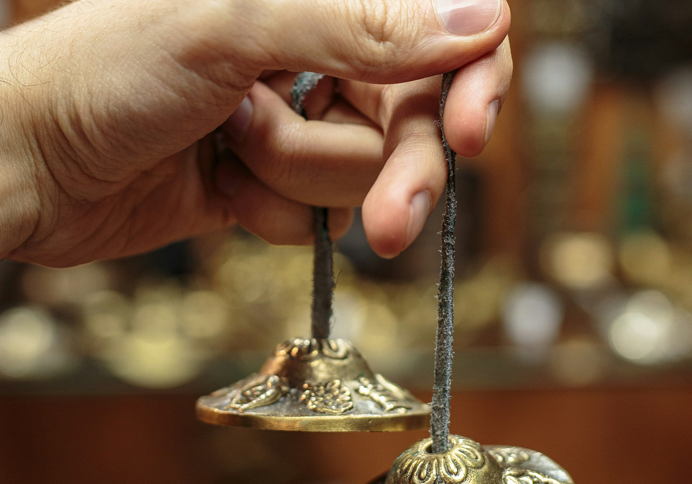 hand holding traditional tibetan chimes