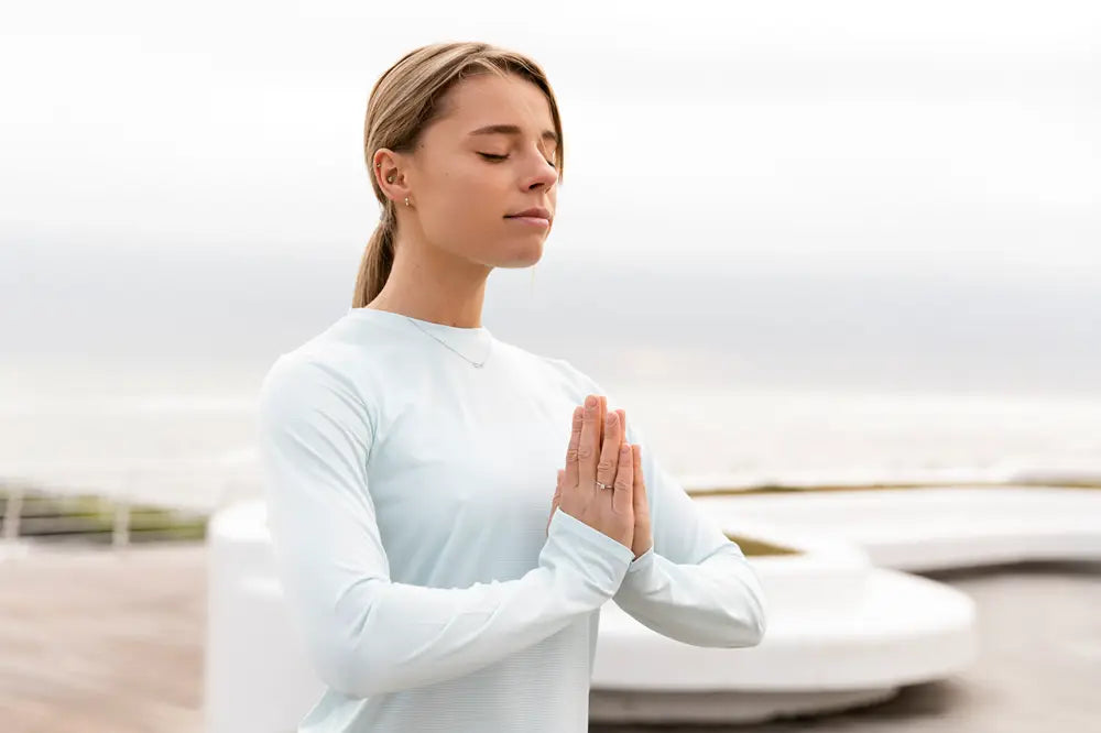 peaceful woman outside hands at heart centre