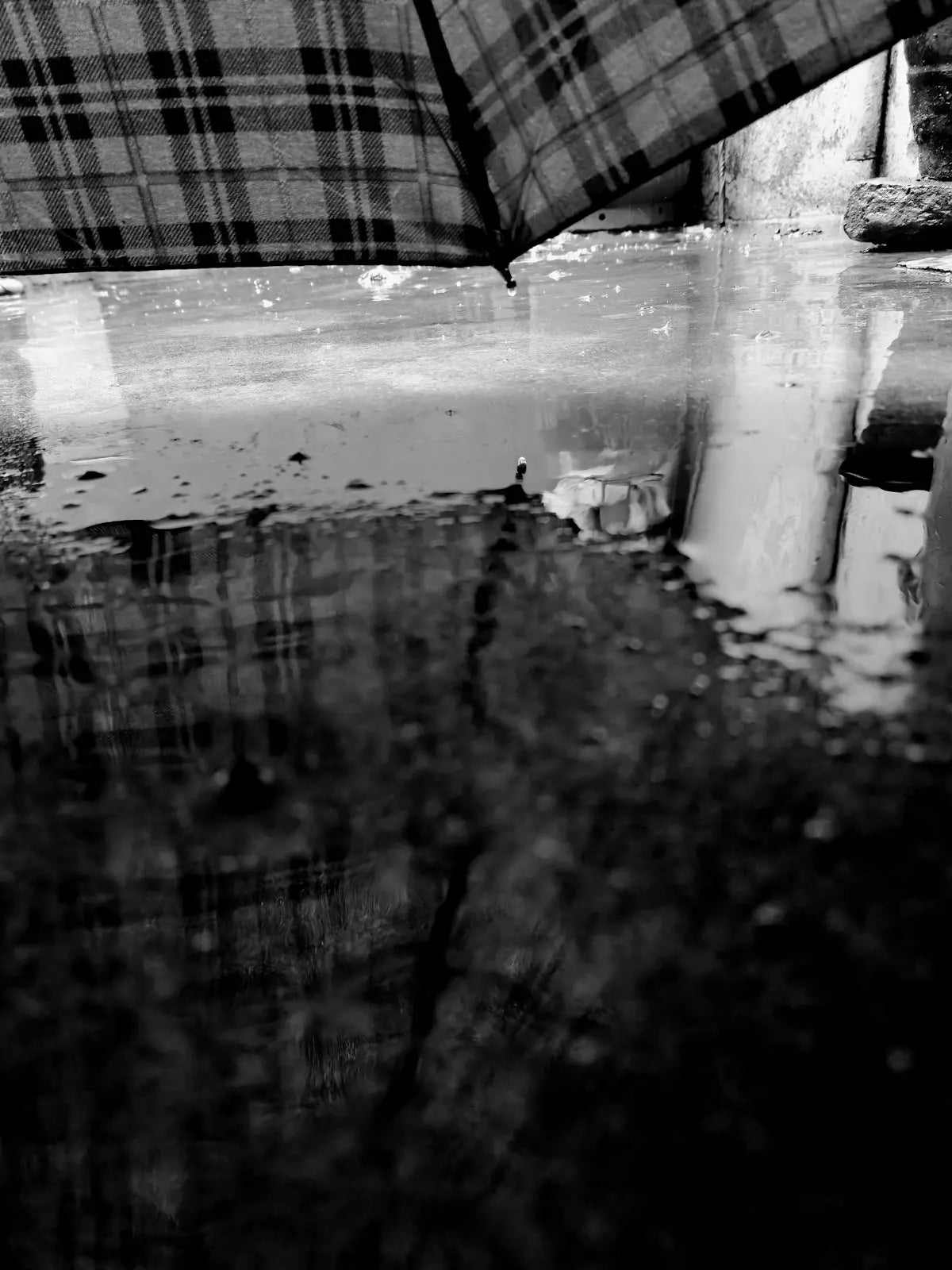 A black and white photo of a person holding an umbrella