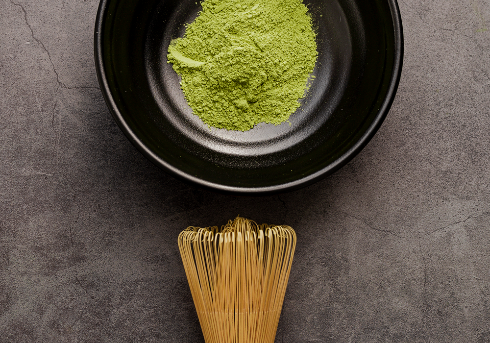 matcha powder in bowl with whisk