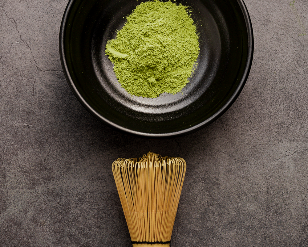 matcha powder in bowl with whisk