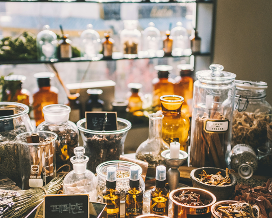 table and shelves of traditional Chinese medicinal herbs