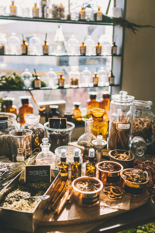 table and shelves of traditional Chinese medicinal herbs