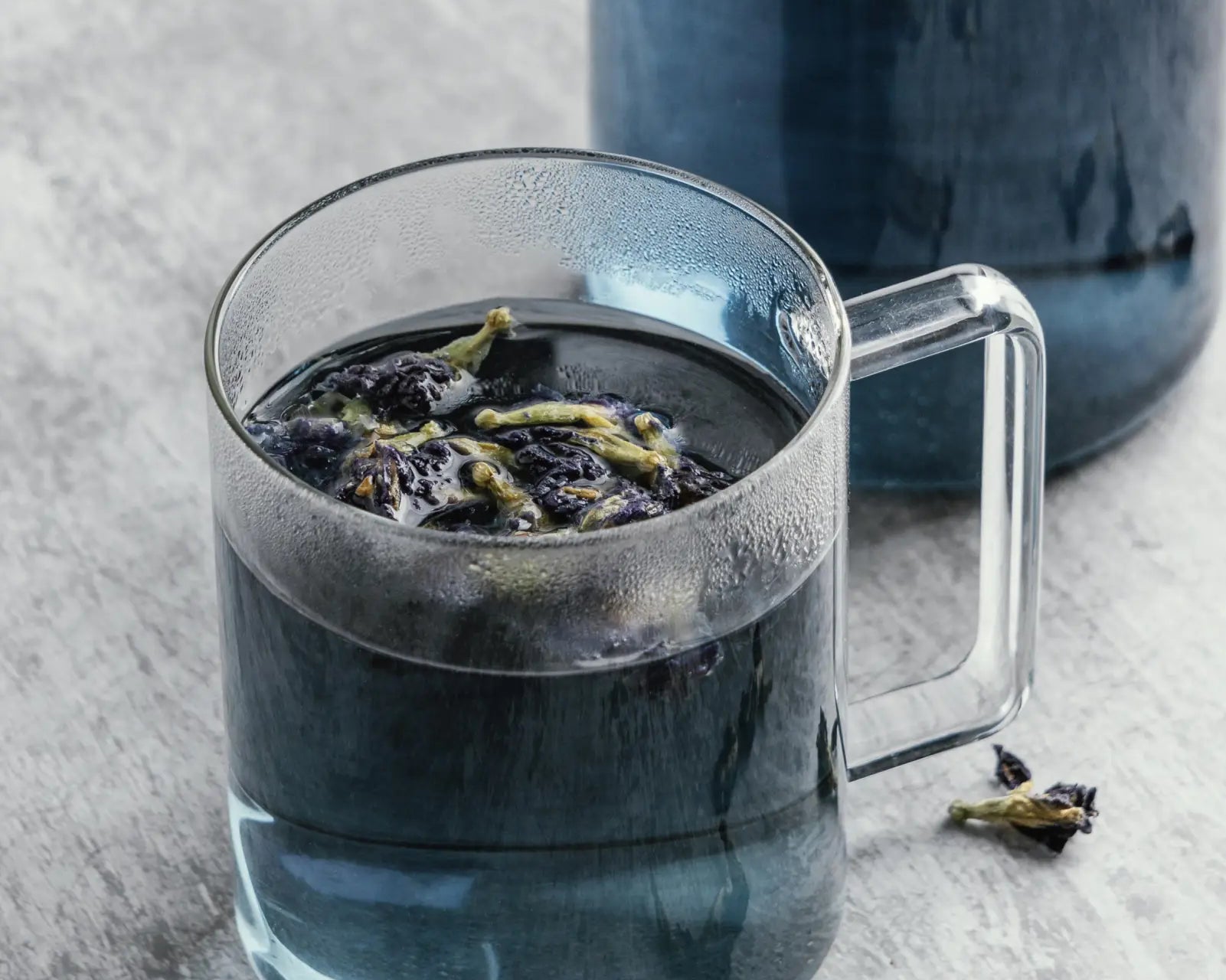 blue lotus flower tea in glass cup