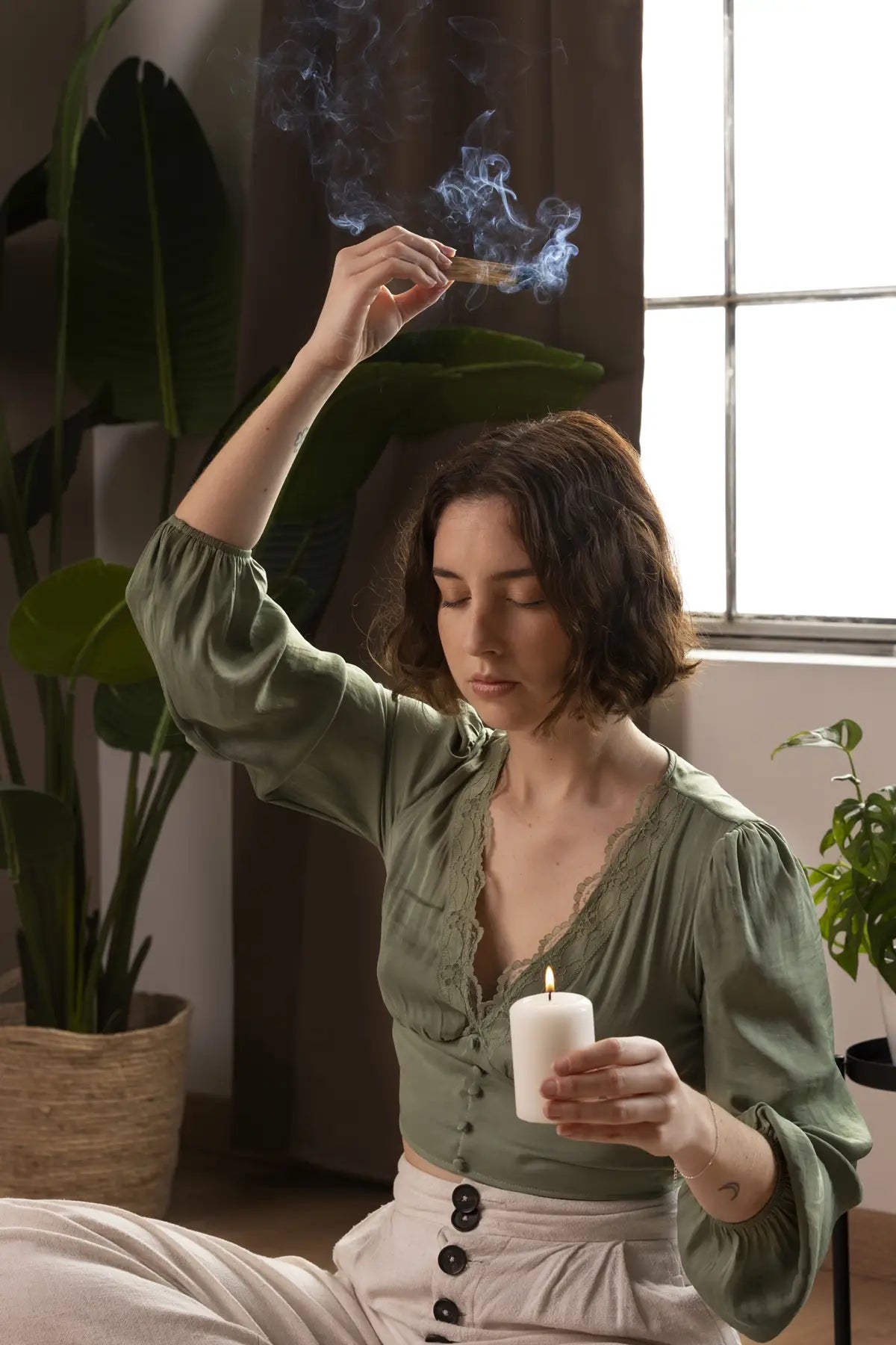woman smoke cleansing with palo santo