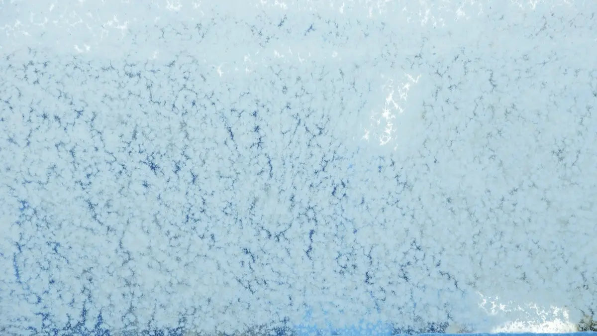 a close up of a blue and white wall