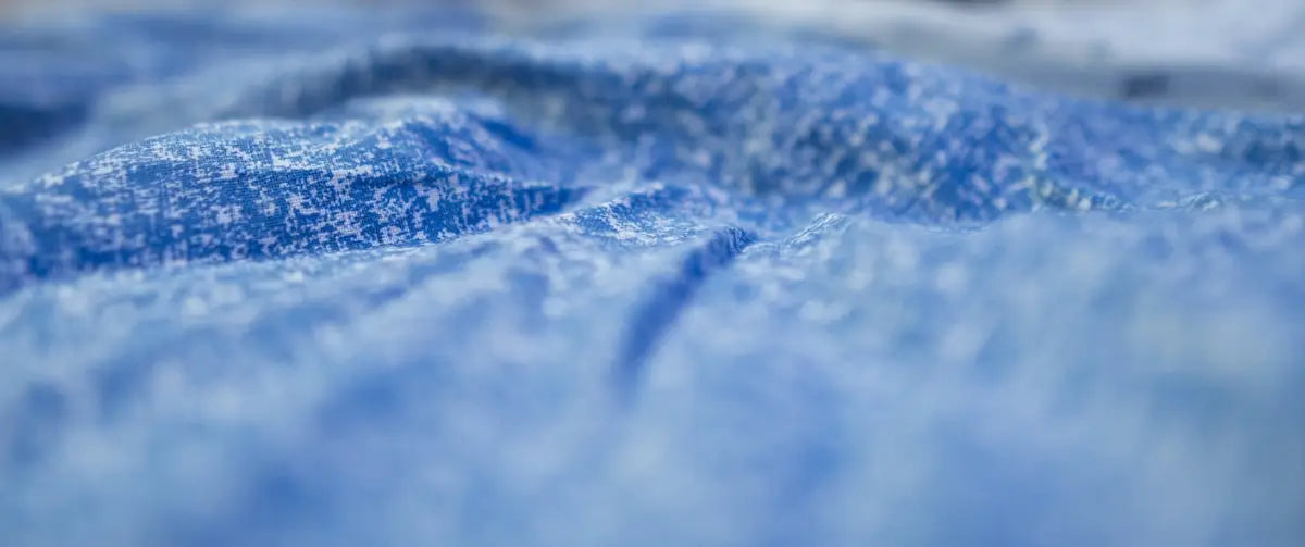 a close up of a blue cloth with a blurry background