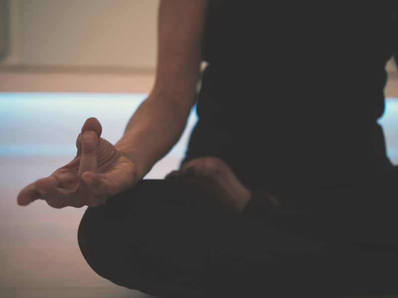 woman meditating at home showing mudra