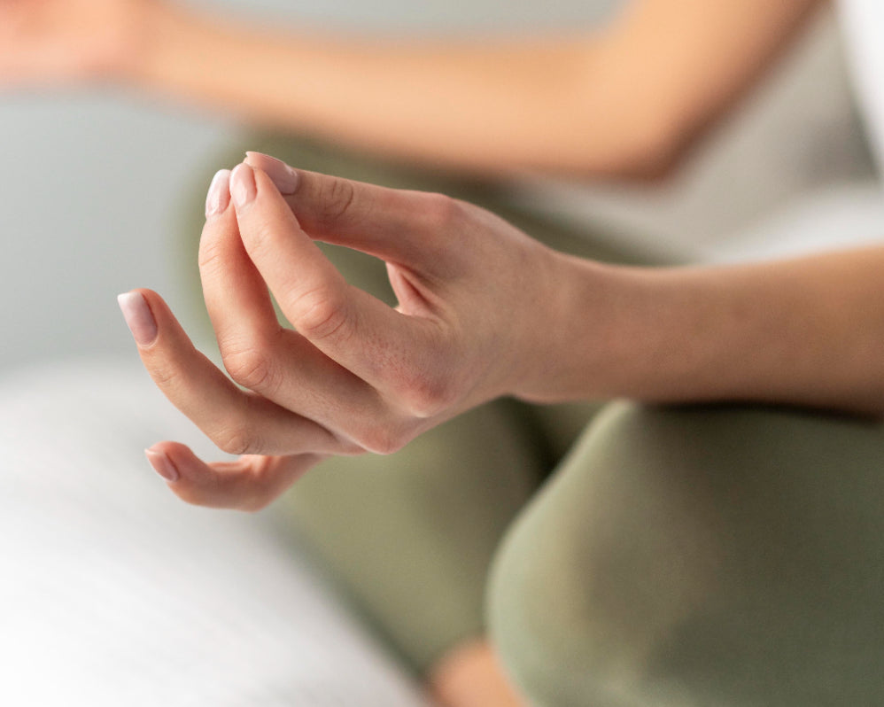 woman meditating on cream meditation cushion