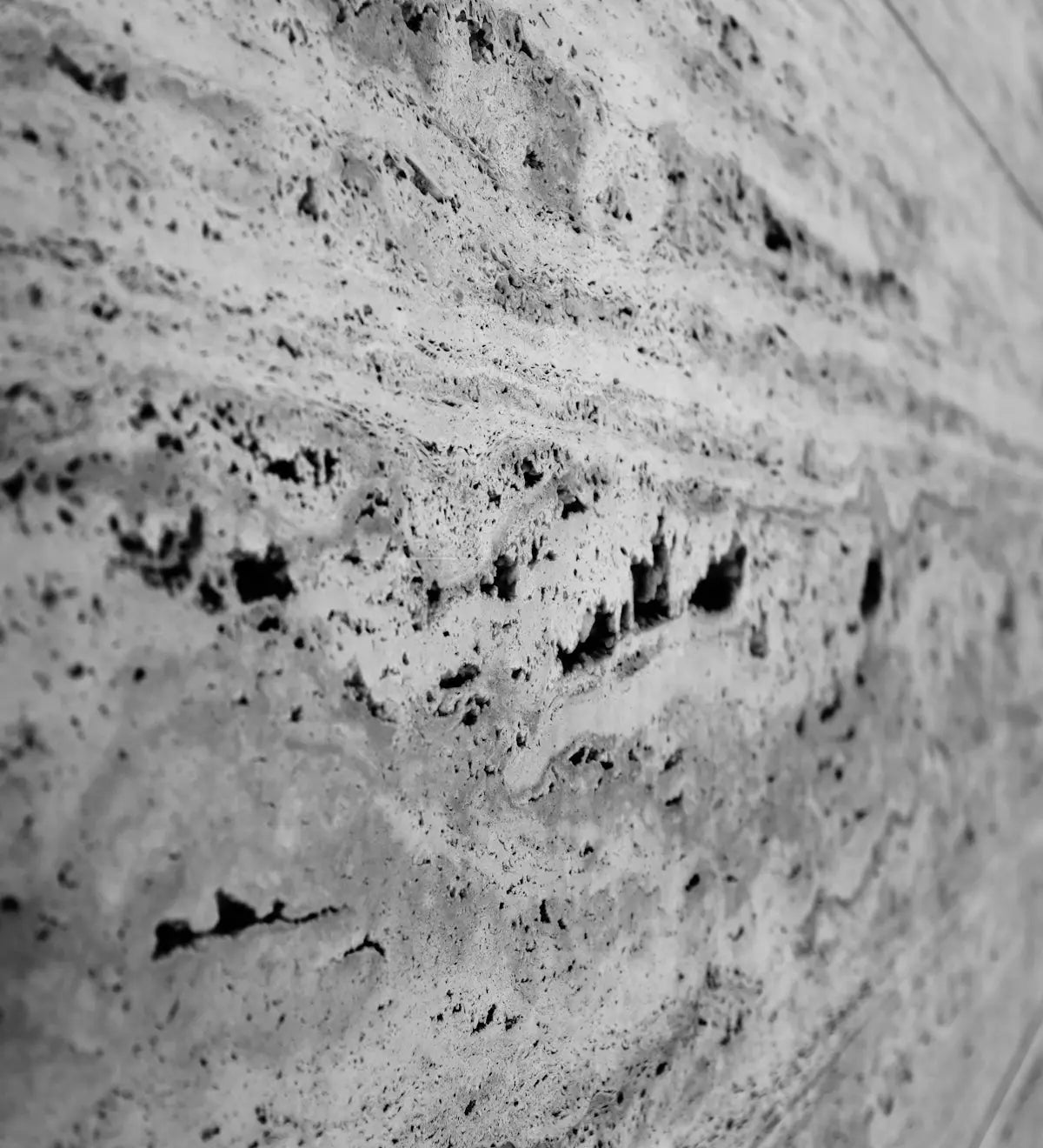 a black and white photo of a stone wall