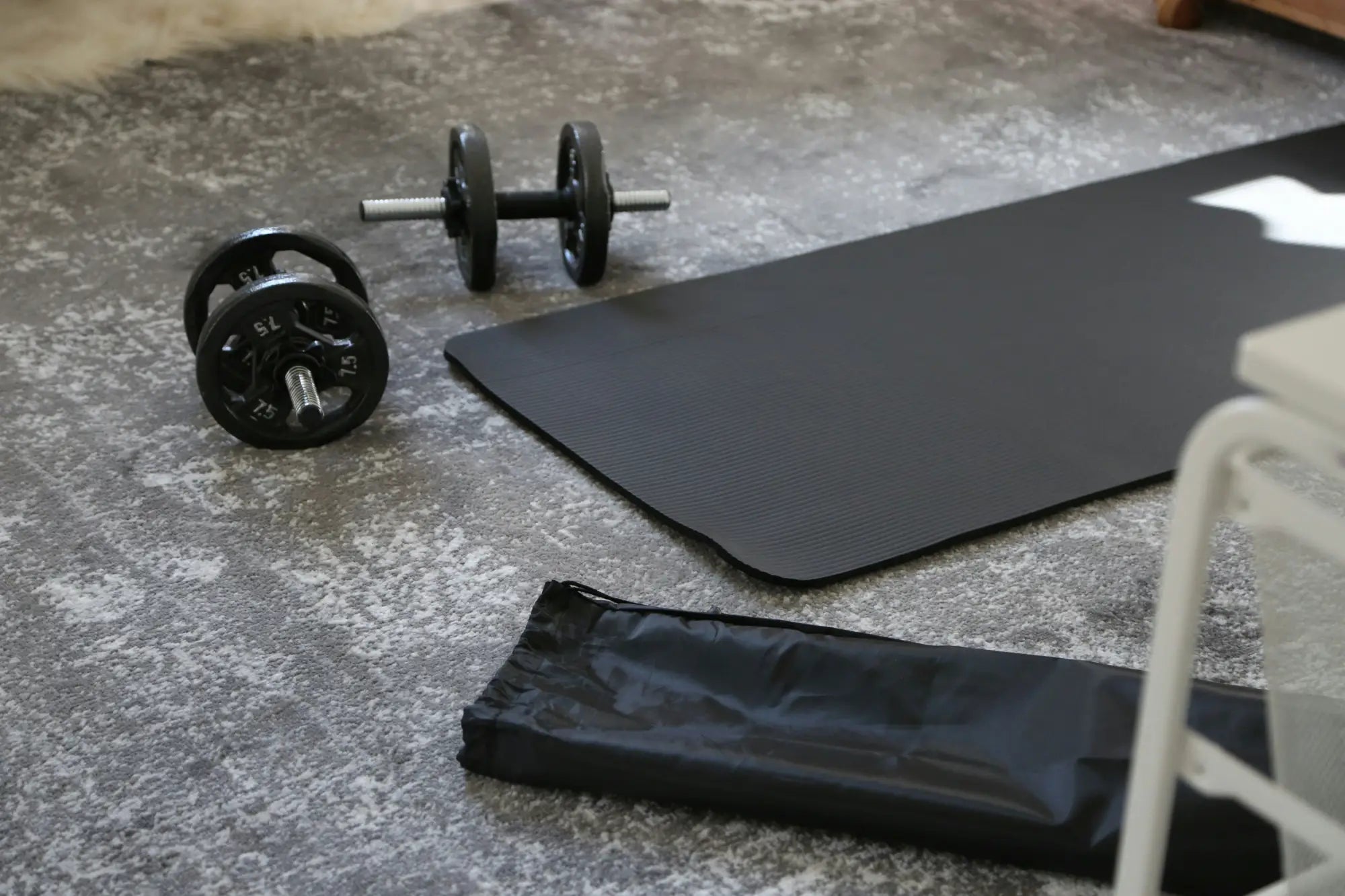 black yoga mat and towel on floor