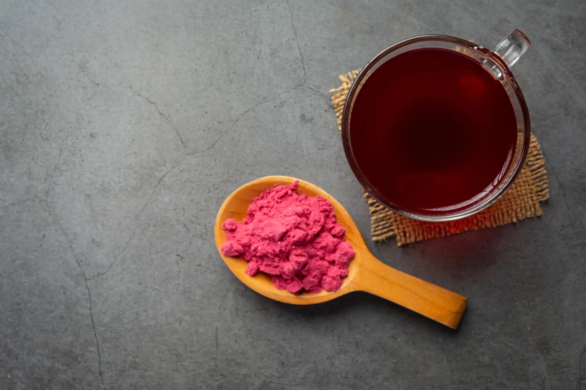 beetroot powder on spoon next to cup