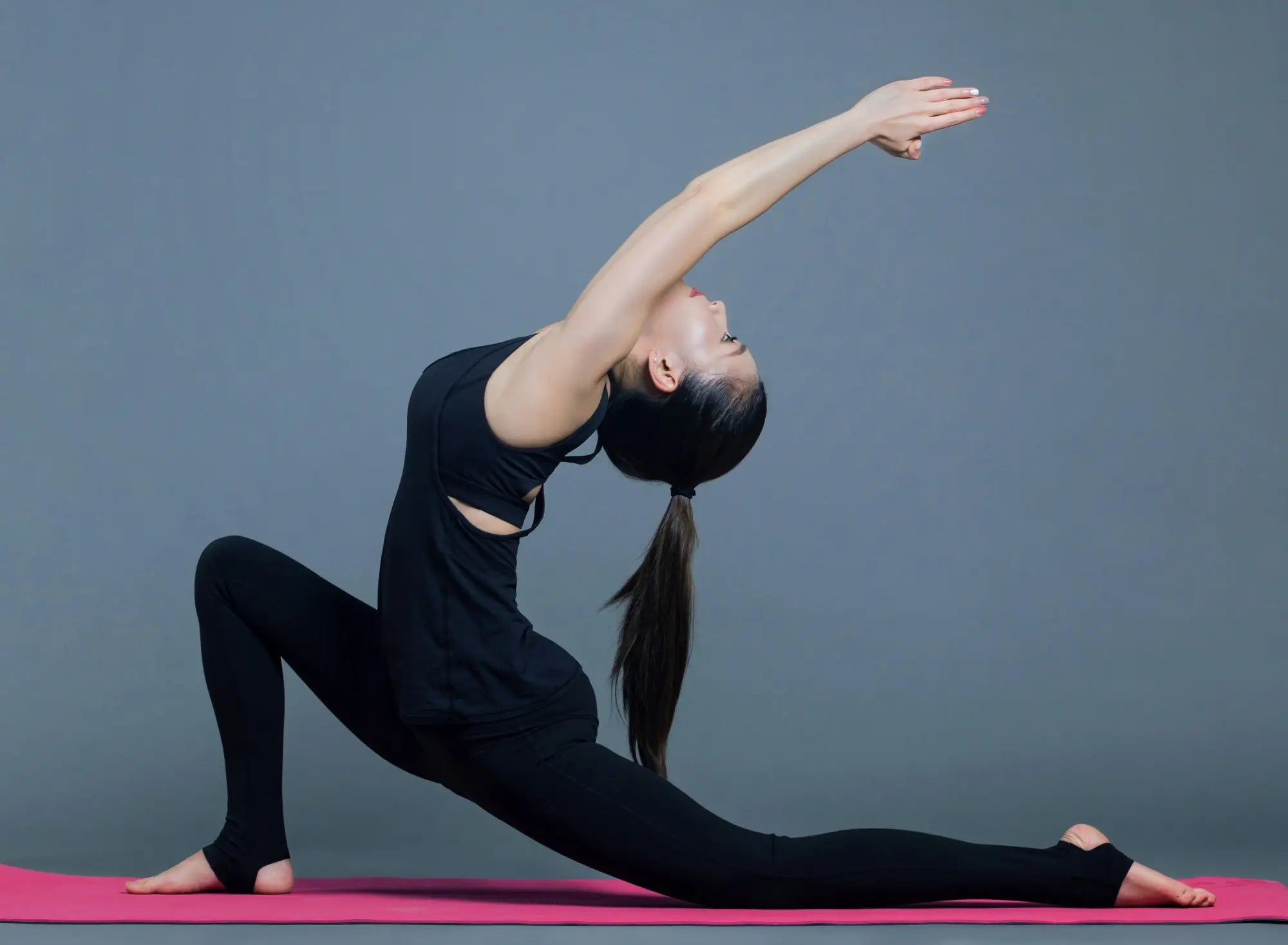 woman doing yoga on pink mat